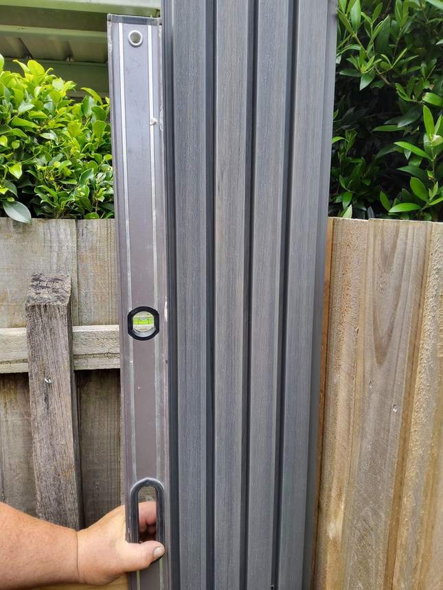 Spirit level on smoke grey composite cladding, Heidelberg