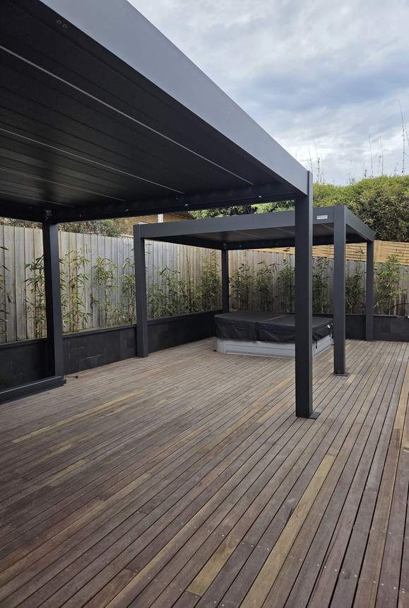 Twin Pergolux louvred pergolas installed over Merbau deck with recessed spa — Jan Juc, VIC