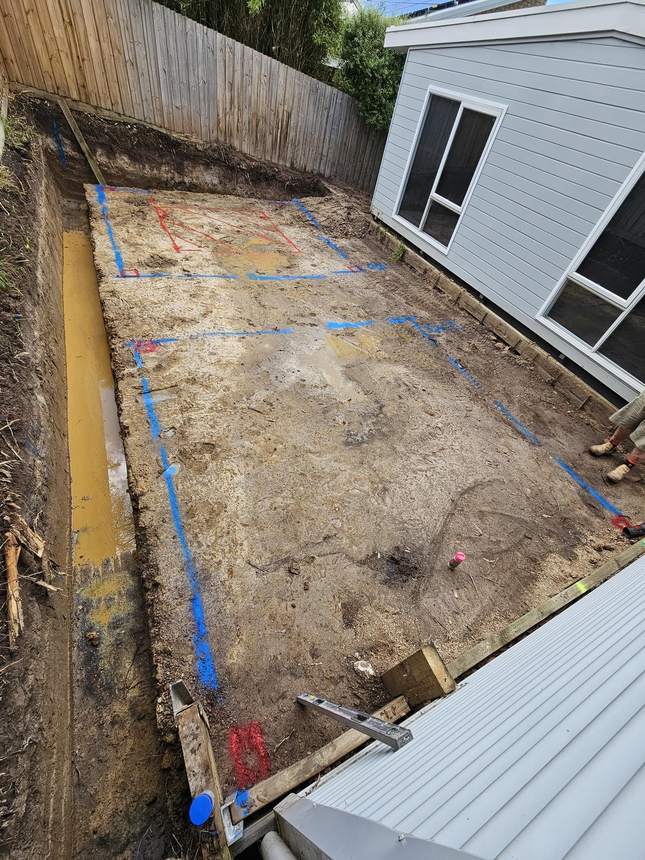 Overhead view of the fully excavated footprint with blue tape layout markings