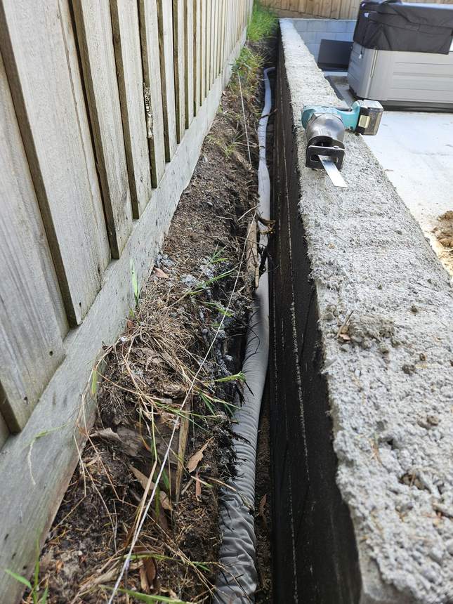 AGI agricultural drain pipe installed at the base of retaining wall at Jan Juc — My Home My Garden