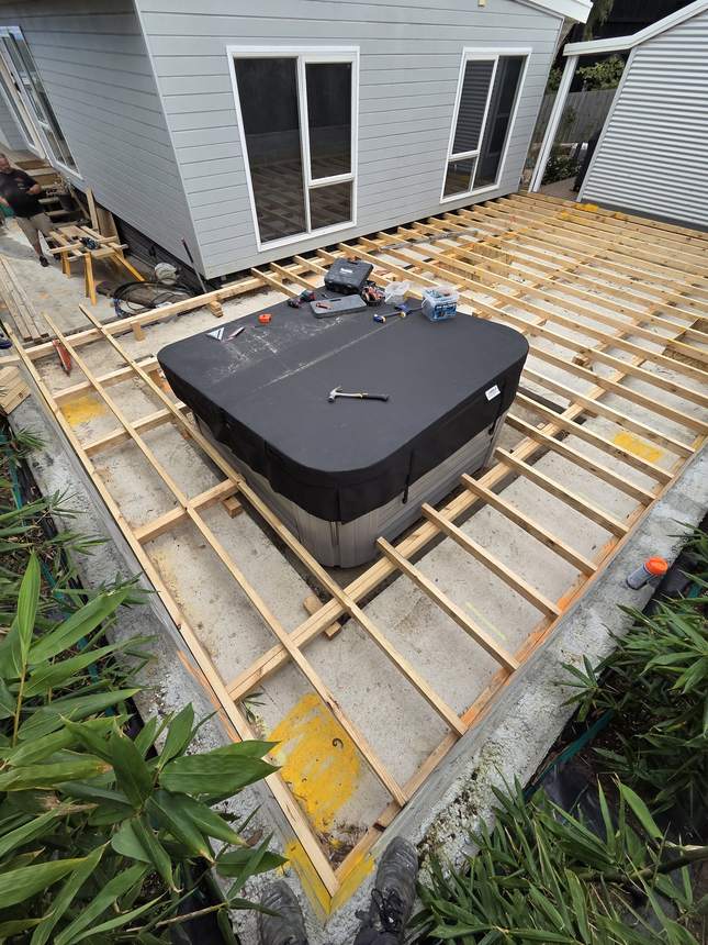 Overhead view looking down into the complete deck frame with spa positioned within it
