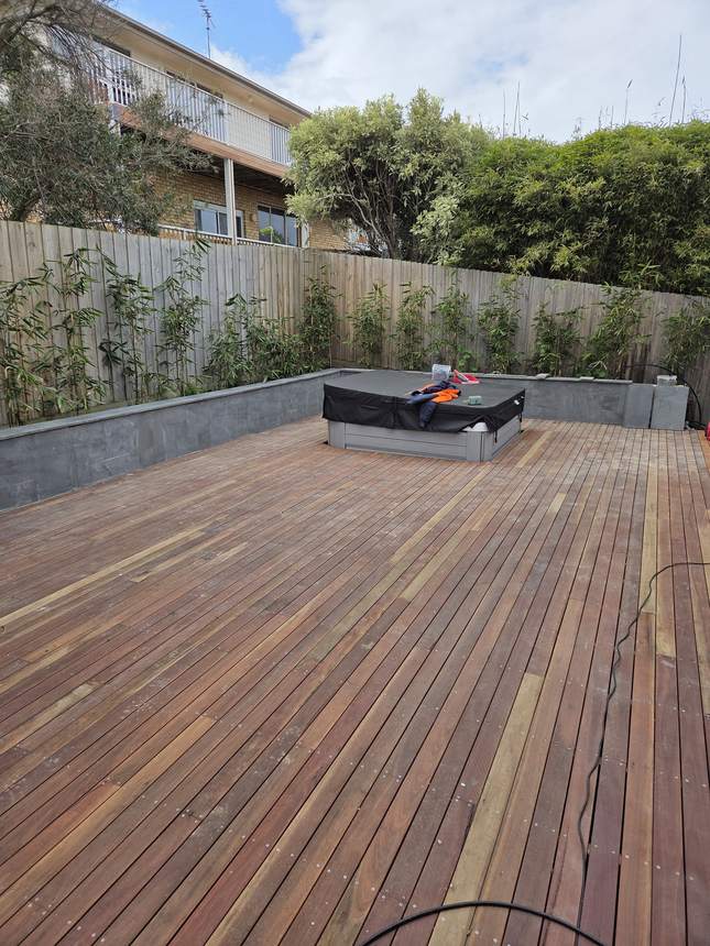 Merbau decking laid across full area with spa sitting on deck and bamboo behind