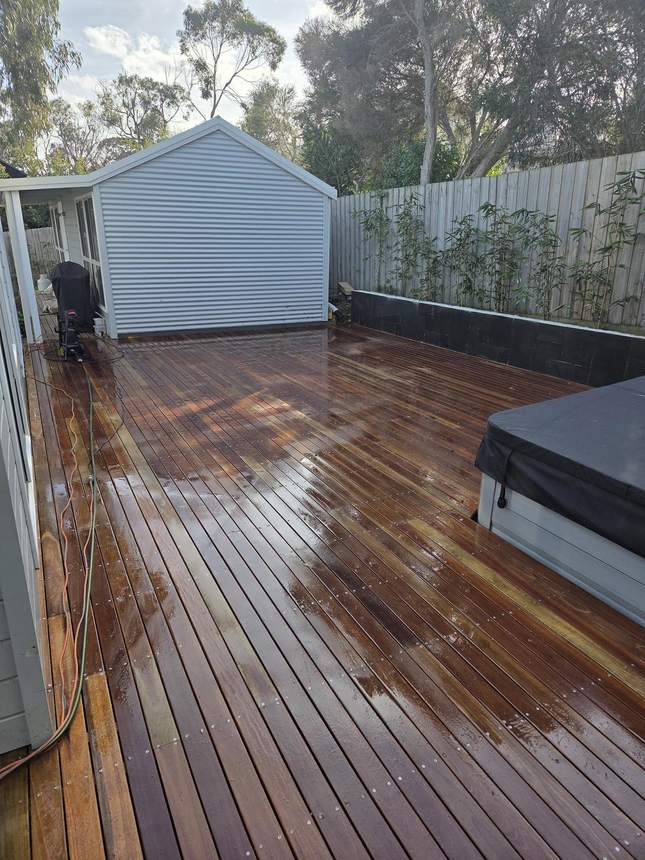 Merbau deck being pressure washed showing rich grain