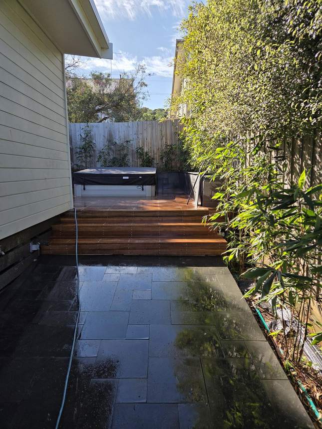 Looking along the completed bluestone wall with bamboo overhead and deck below