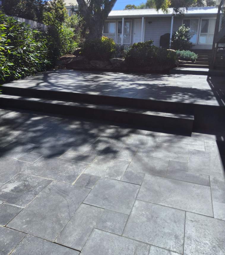 Dark slate paving and stepped tiers at Jan Juc entertaining zone — My Home My Garden