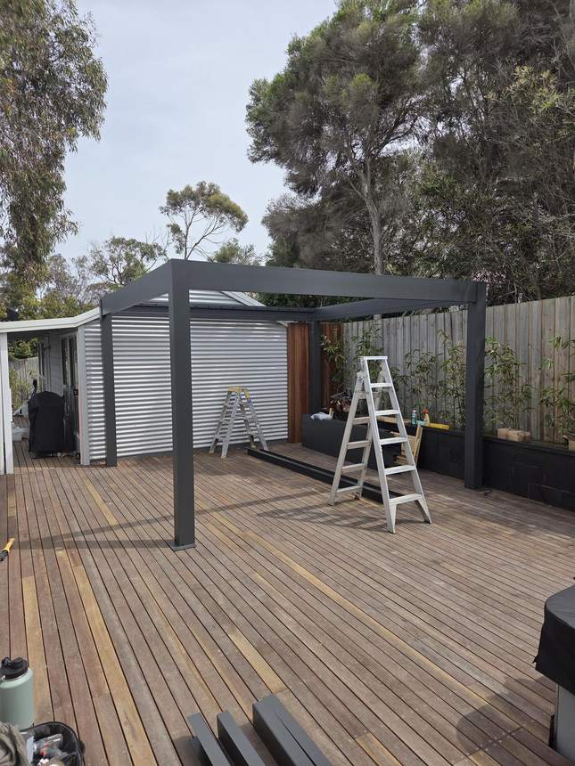 Pergolux pergola frame going up with corrugated roof being installed