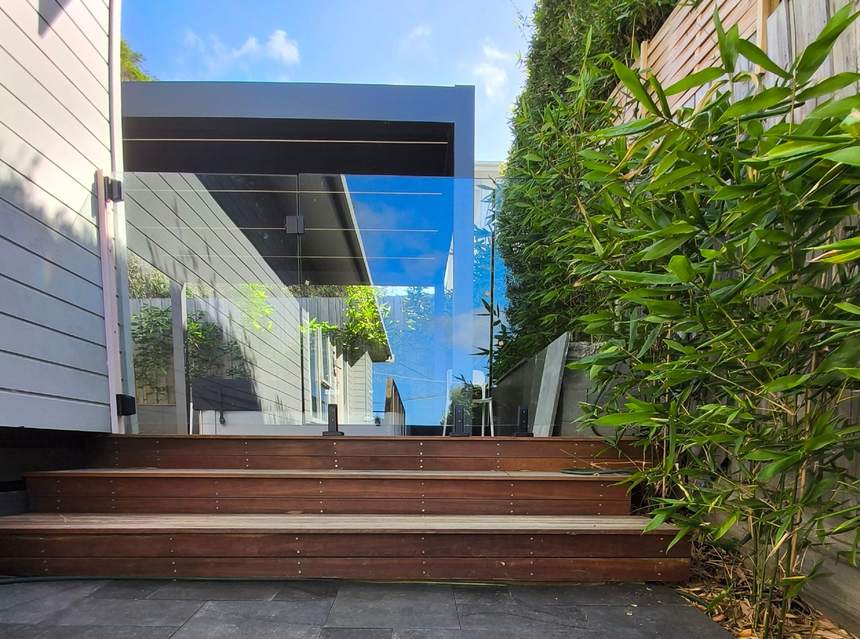 Timber steps and glass balustrade leading to deck