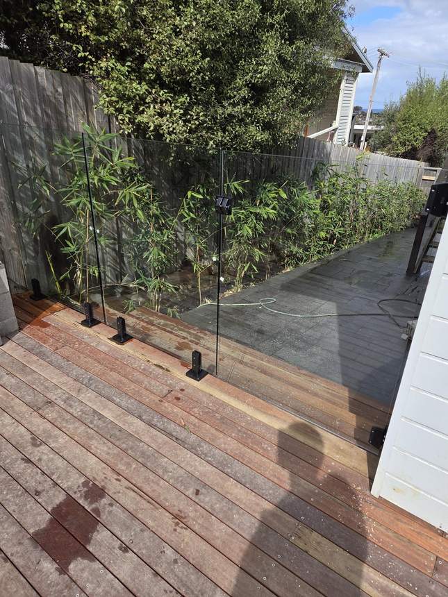 Glass balustrade and Merbau deck with bamboo backdrop