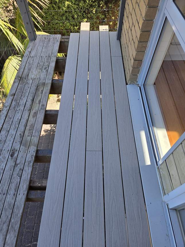 Ash Grey composite boards partially installed — new boards contrasting with old weathered timber below, Jan Juc