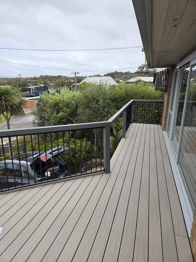 New aluminium frame balustrade running the deck perimeter with Surf Coast views beyond — Jan Juc