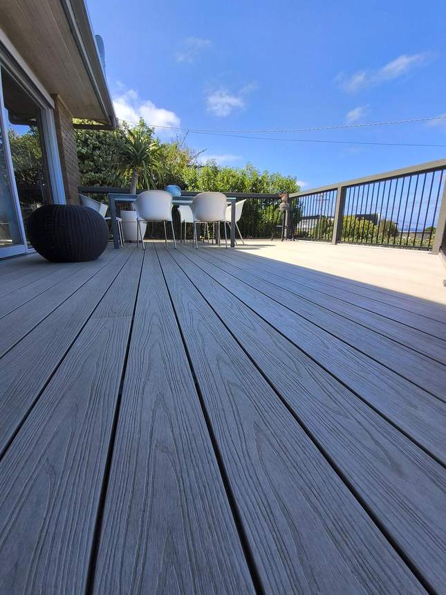 Looking along deck with outdoor chairs in background — Jan Juc