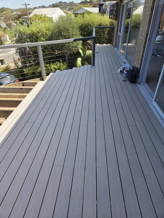 Ash Grey composite deck nearing completion with the new aluminium balustrade beginning to go in — Jan Juc