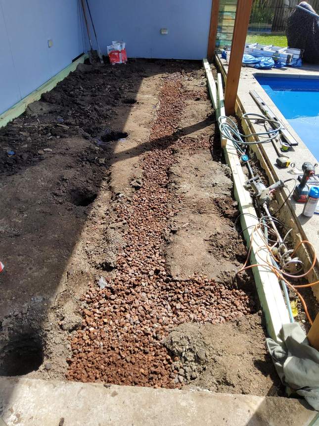 Scoria aggregate over agi pipe in drainage trench — Pakenham pool deck build, My Home My Garden