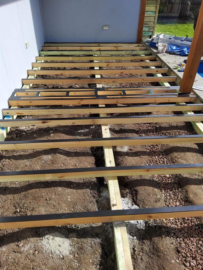 New structural framing alongside the pool edge — posts and uprights ready for composite boards, Pakenham