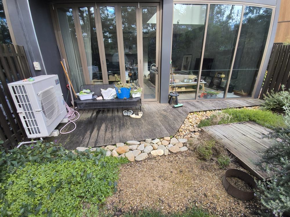 Original timber deck against the glass doors with garden in front