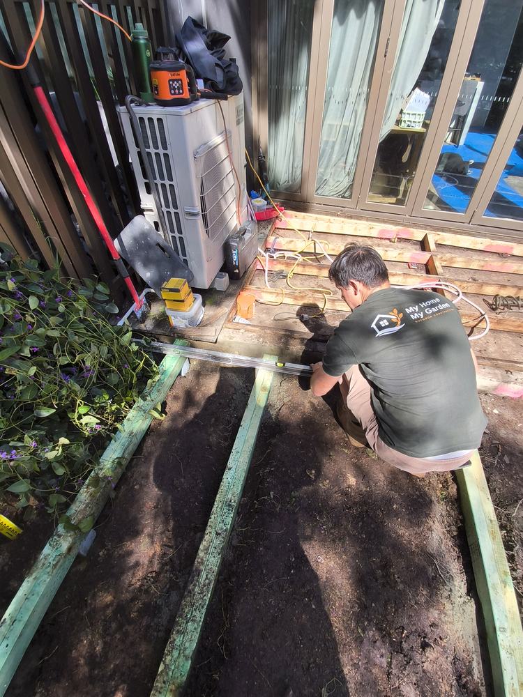 Joist being levelled where the new frame ties into the existing frame