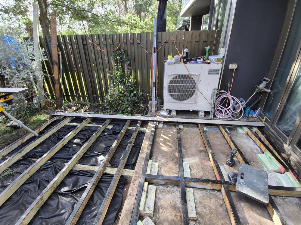 Weed mat laid under the new deck frame