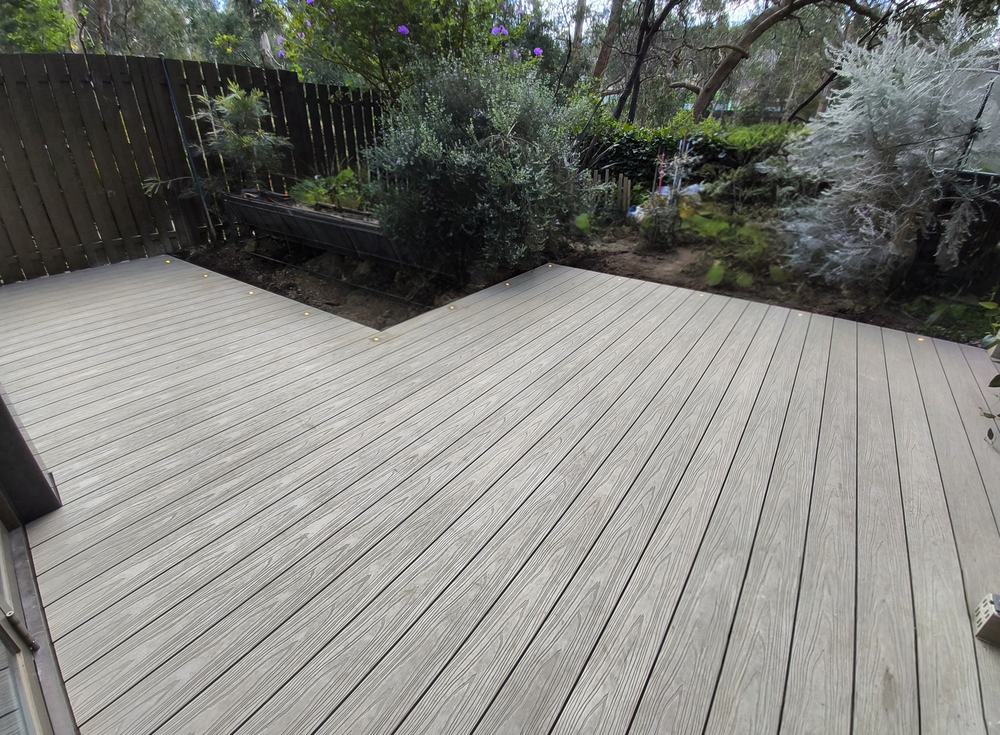 Finished composite deck with deck lights set into the boards