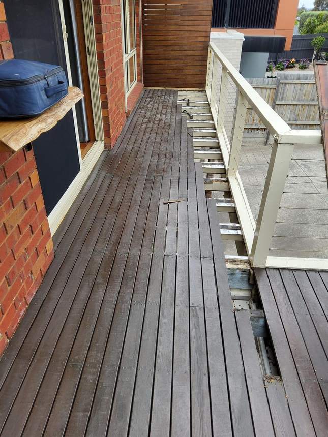 Failed, rotten timber subframe exposed beneath the old deck — the hidden safety hazard, Seaford