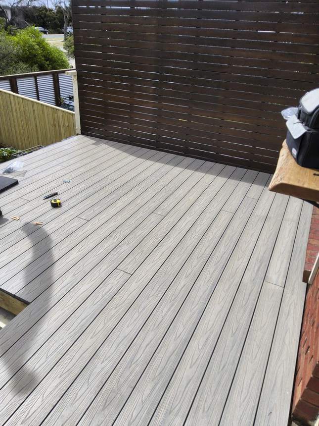 Deck surface nearing completion — Beach composite boards level and solid across the rebuilt frame, Seaford