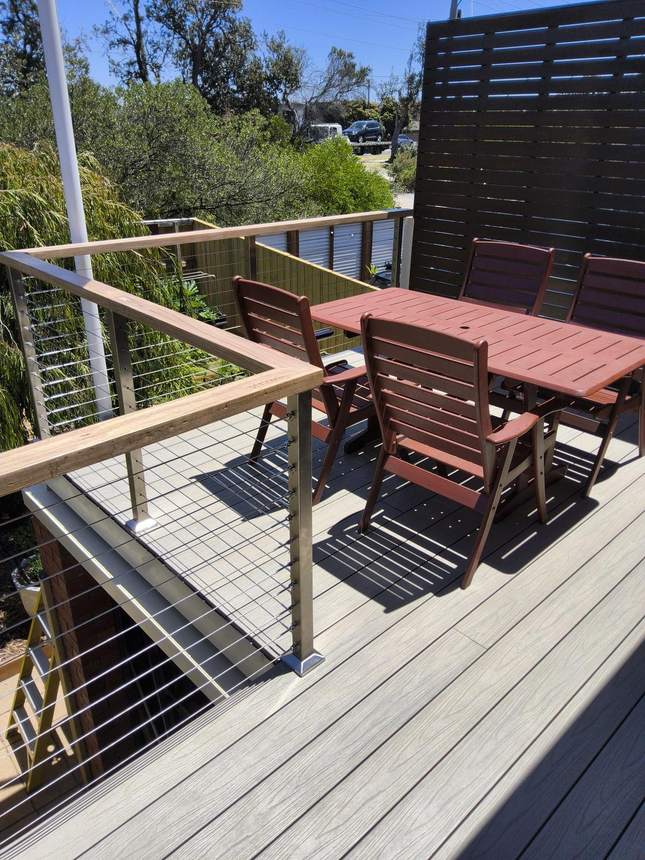 Balustrade detail — Tasmanian oak handrail and wire cables at the corner post, Seaford