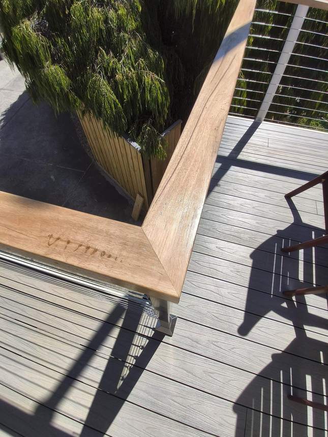 Full deck view — Beach composite, Tasmanian oak handrail, consistent wire spacing throughout — Seaford