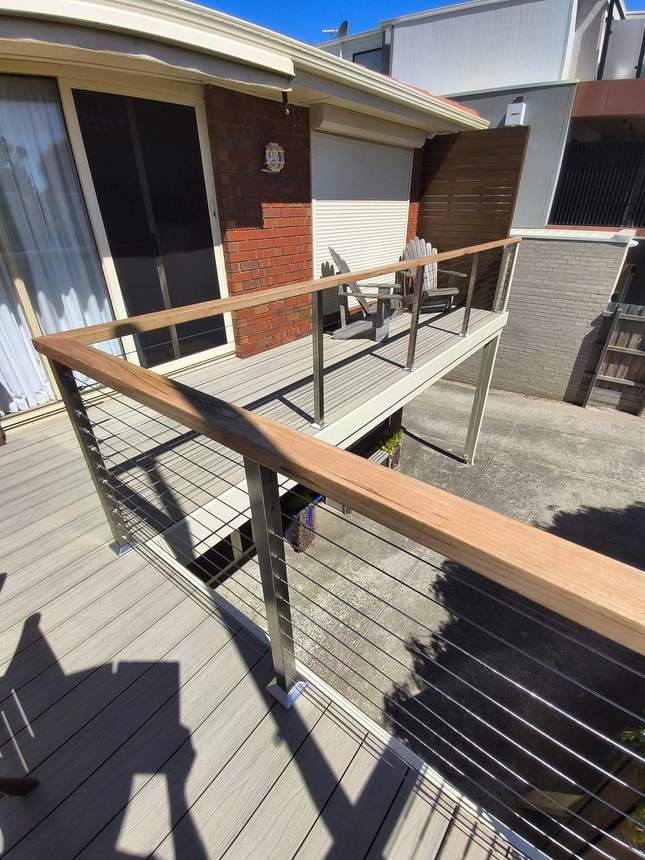 The finished composite deck end to end with marine-grade wire balustrade and Tasmanian oak handrail — Seaford