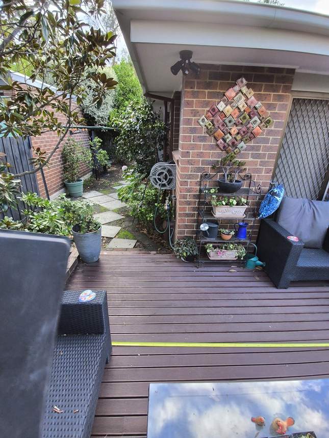Step down from the deck onto a run of old uneven pavers into the side garden — Surrey Hills