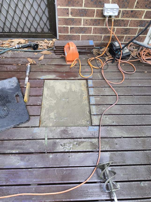 Steel post bracket set into a concrete footing for the pergola post — Surrey Hills