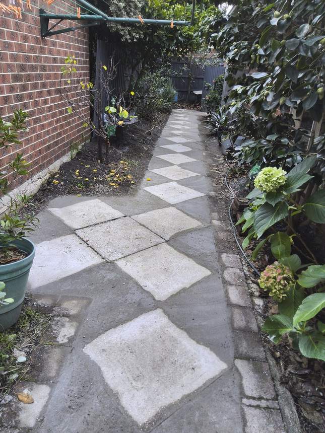 Concrete trailed around the existing pavers to create a flush level surface — Surrey Hills