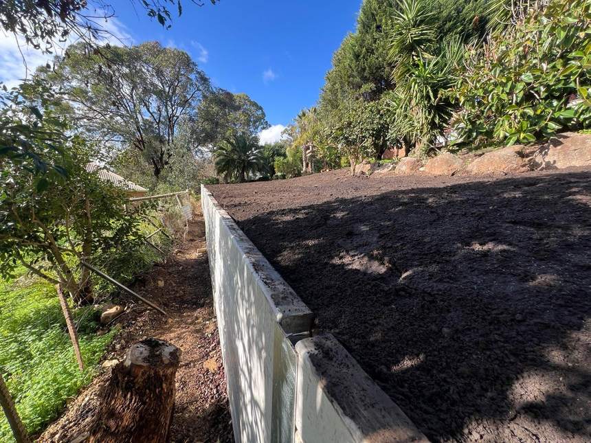 The reclaimed level space behind the finished retaining wall — Templestowe