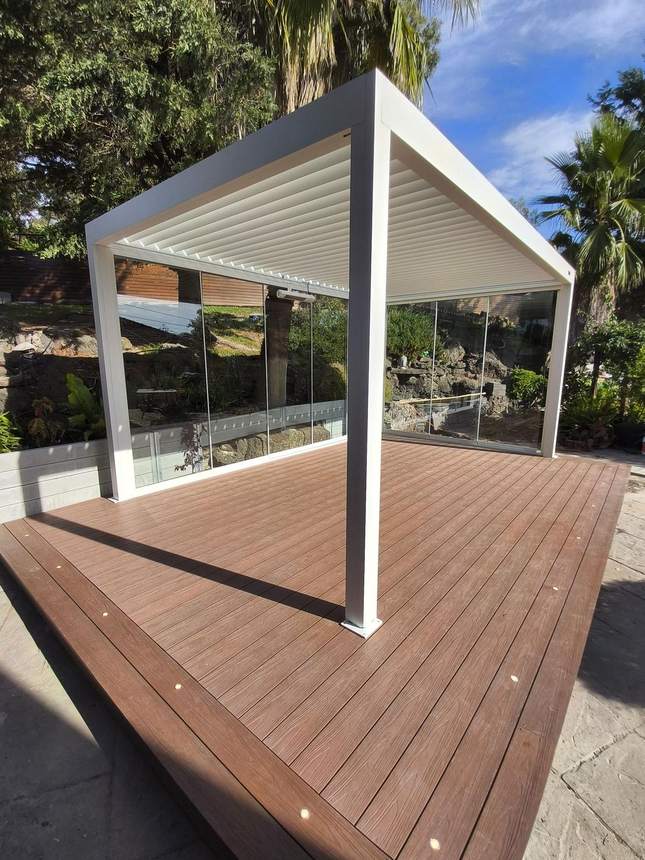 Pergola frame assembled on deck — sliding glass doors, heater overhead, Templestowe