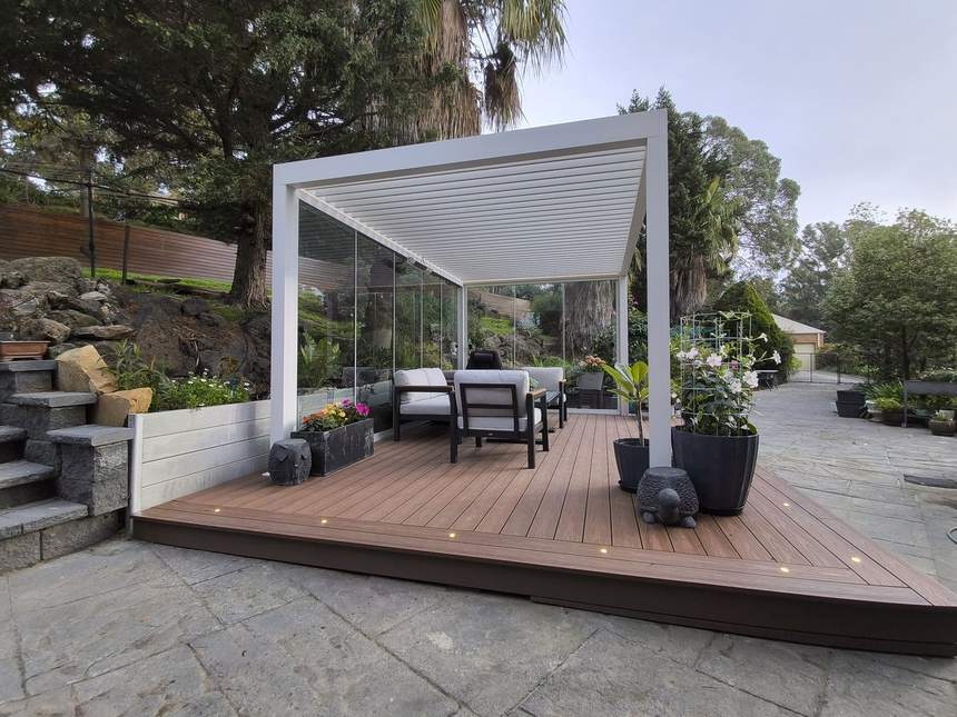 Louvres open, furniture in — the finished outdoor room in use — Templestowe